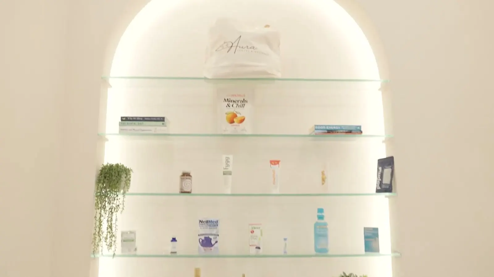 The biocompatible product shelf in the arched niche at Aura Dental and Wellness